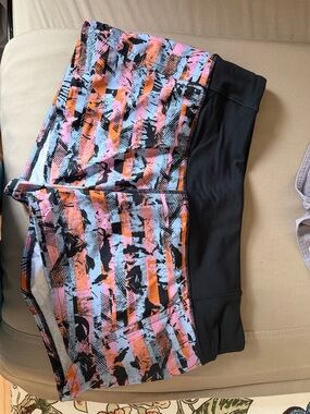 Lululemon speed up mid rise 4 “ shorts . Never worn. Size 6 pink, orange stripe